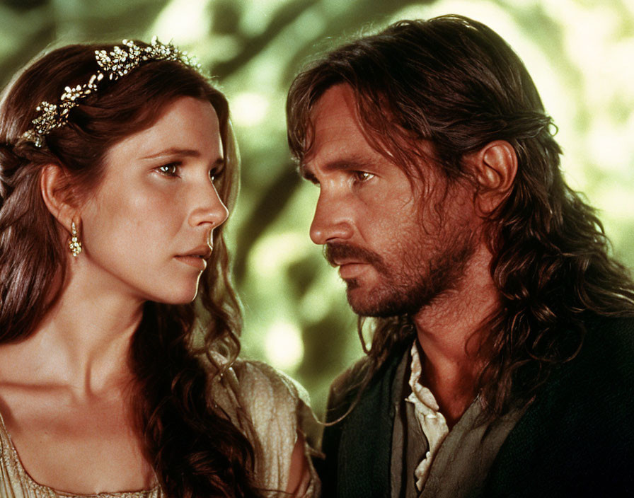 Medieval-themed image: Woman in tiara gazes at man with long hair and beard