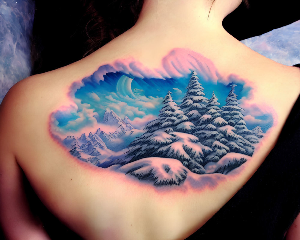 Colorful back tattoo of heart-shaped mountain landscape with pine trees and sky.