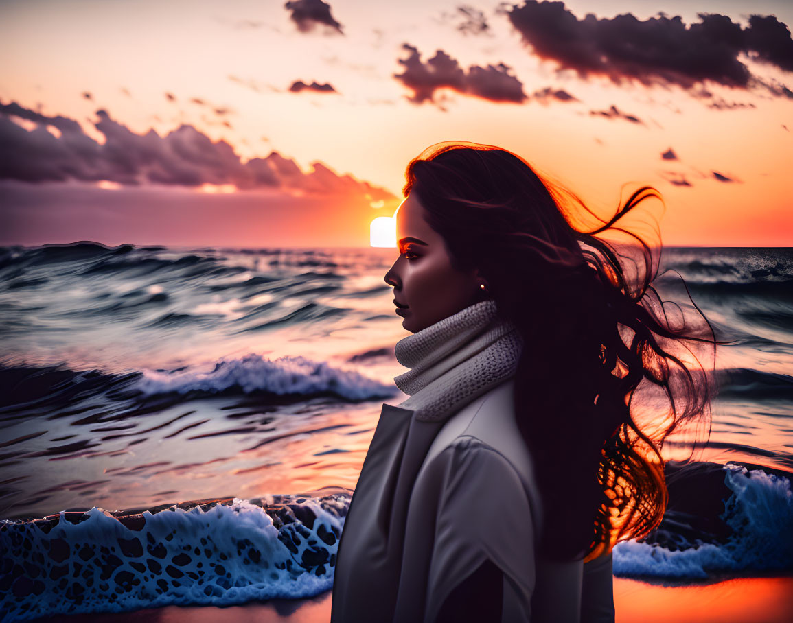 Profile of woman watching ocean sunset with windy hair and dramatic sky