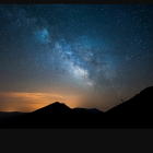 Nighttime gathering around bonfire under starry sky with Milky Way.