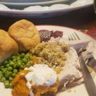 Roasted Turkey on Festive Table with Autumn Leaves and Wine