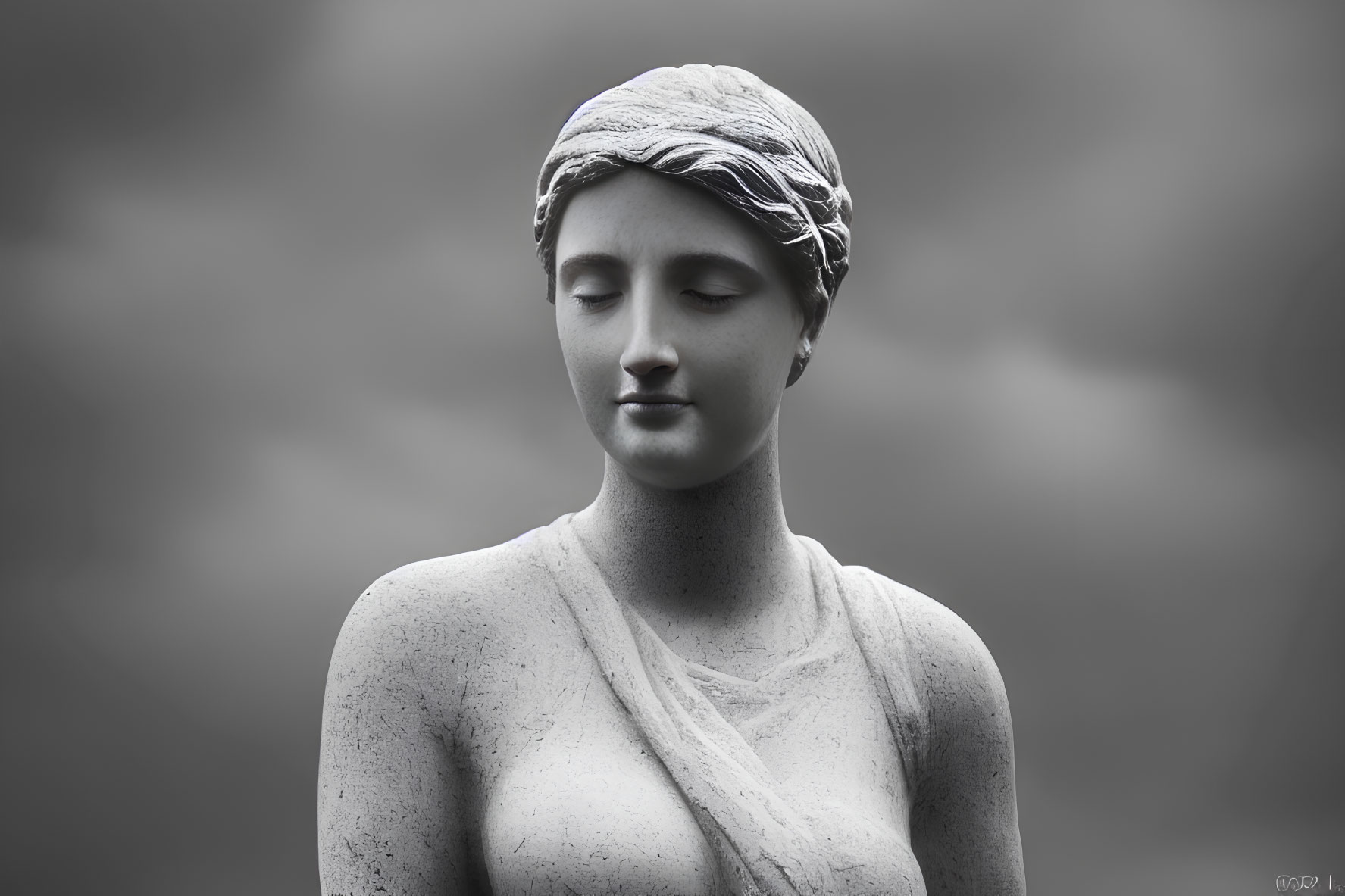 Monochrome photograph of serene woman statue with headscarf