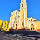 Colonial church with twin bell towers and horse-drawn carriage at twilight