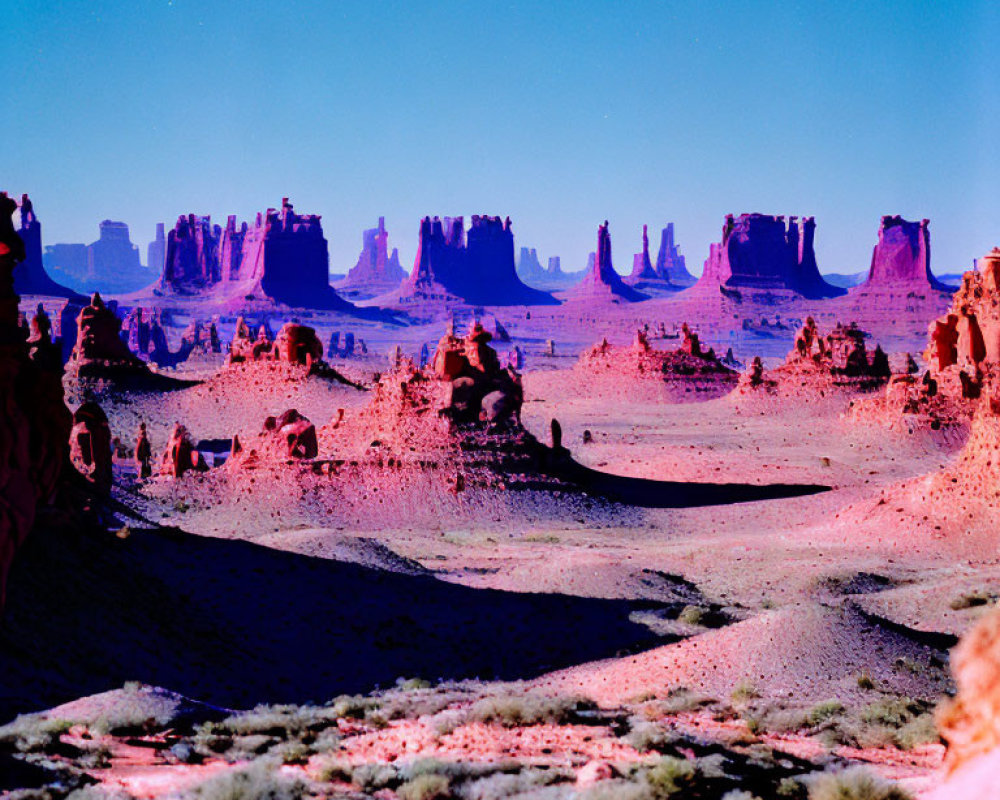 Iconic Monument Valley landscape with red rock formations under blue sky