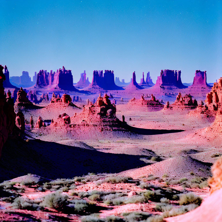 Iconic Monument Valley landscape with red rock formations under blue sky