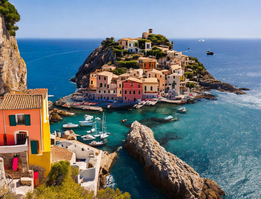 Colorful coastal village on peninsula with anchored boats in clear blue sea