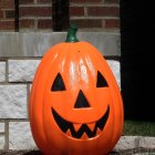 Colorful Pumpkin Lantern and Glowing Tree Design Against Illustrated Buildings