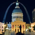 Nighttime fantasy cityscape with arch, mosaic buildings, lanterns & starry sky