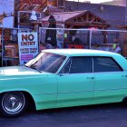 Vintage luxury car in mint green with floral accents