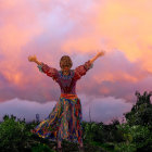 Woman in floral dress enjoying picturesque sunset with rolling hills