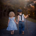 Children walking on flower-lined path holding hands