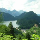 Misty river valley with lush greenery and towering mountains