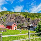 Tranquil countryside scene with stone house, rolling hills, and distant castles