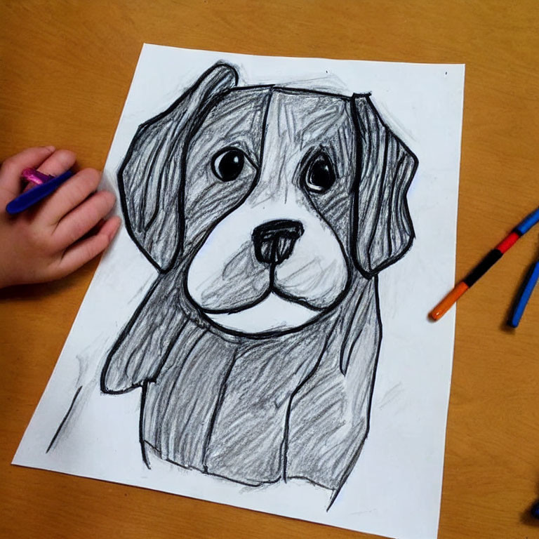 Child coloring cute dog sketch with crayons on wooden surface