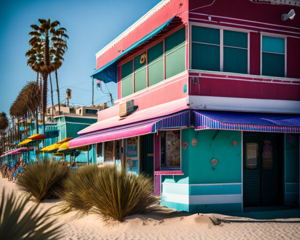 Vibrant pink and blue beachfront buildings near palm trees and sand