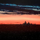 Apocalyptic city skyline under dramatic multicolored sky with ominous clouds