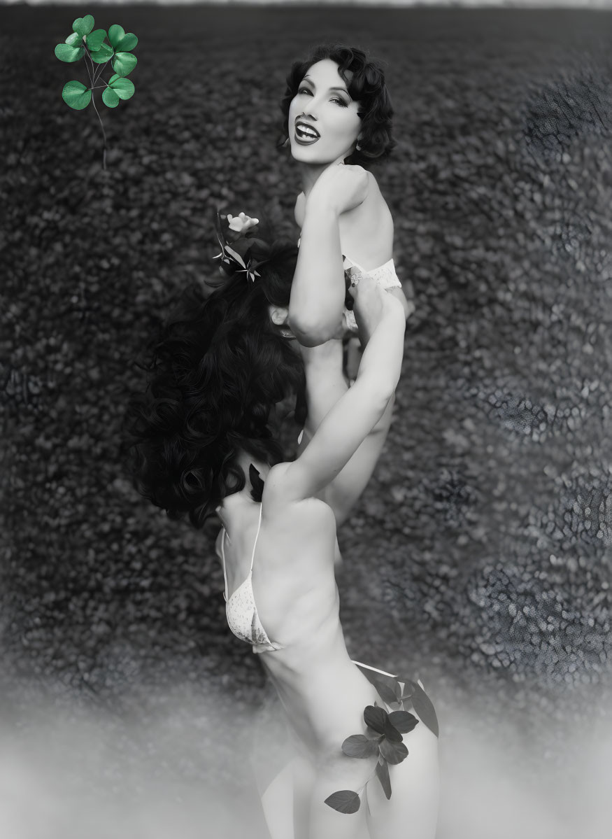 Monochrome photo of woman smiling with clover on mirrored surface