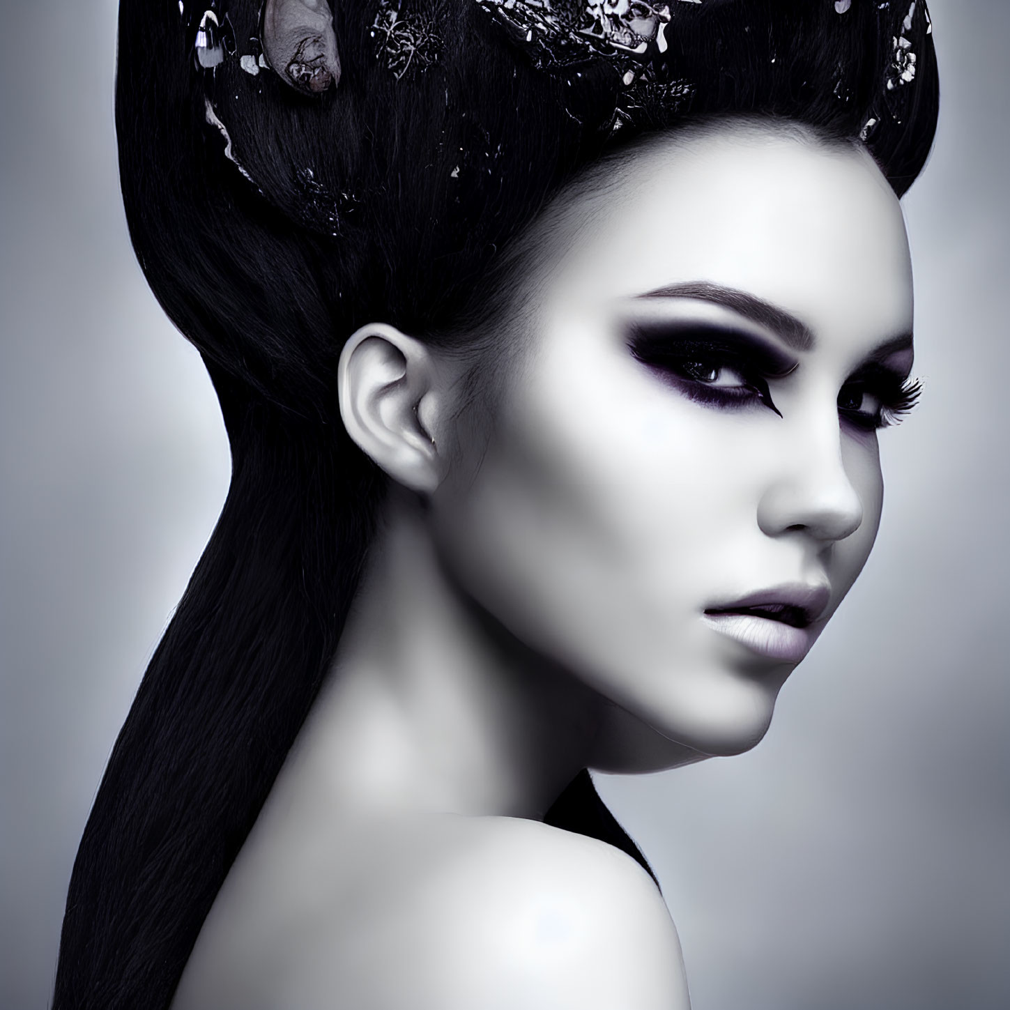 Monochrome portrait of woman with dark makeup and elaborate hairstyle