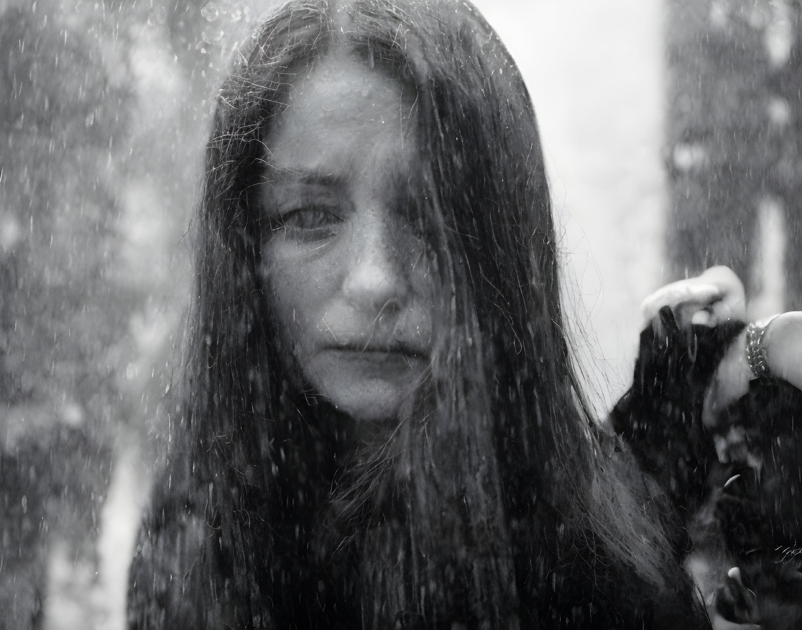 Melancholic woman with wet hair in snowscape portrait