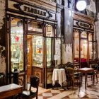 Vintage-style Cafe with Wooden Tables, Glass Cases & Warm Lighting