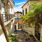 Colorful Watercolor Painting of European Alleyway with Buildings and Trees