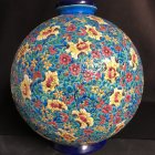 Blue Vase with Gold and Silver Floral Patterns on Dark Background