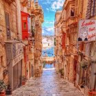 European Alleyway Watercolor Painting with Cobblestones and Warm Buildings