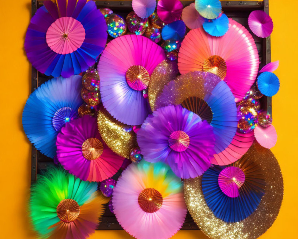 Colorful Paper Fans Arranged on Bright Orange Background