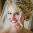 Blonde woman with gold tiara and veil