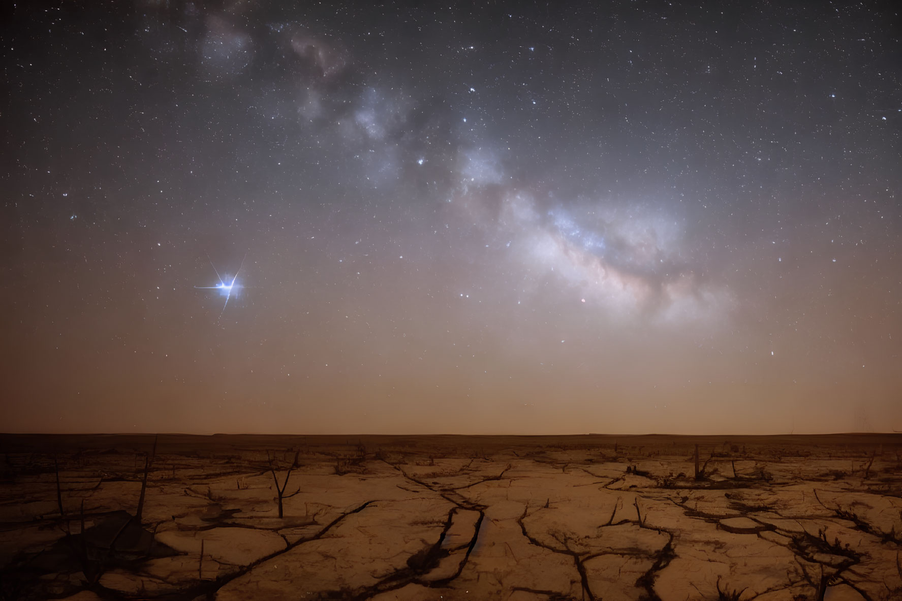 Starry Night Sky with Milky Way and Meteor over Desert Landscape