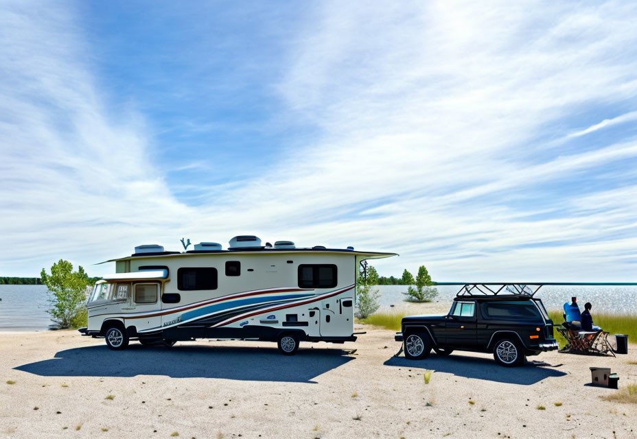 RV and SUV at lakeside picnic with clear blue skies