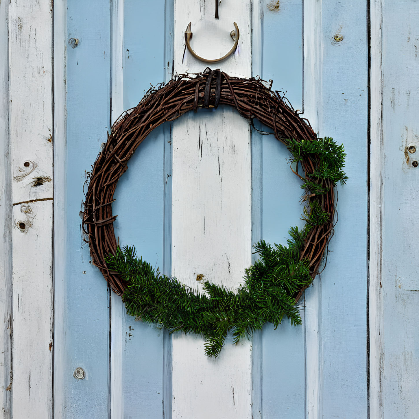 Rustic Twig Wreath with Green Foliage on Blue Wooden Door