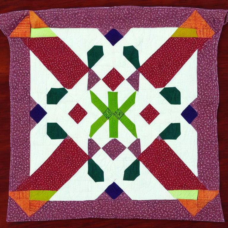 Symmetrical star pattern quilt in greens, purples, and whites