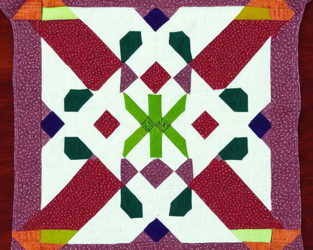 Symmetrical star pattern quilt in greens, purples, and whites