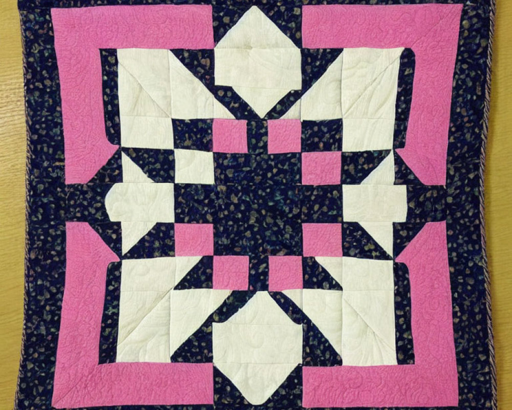 Symmetrical Pink, White, and Navy Patchwork Quilt with Dark Floral Border