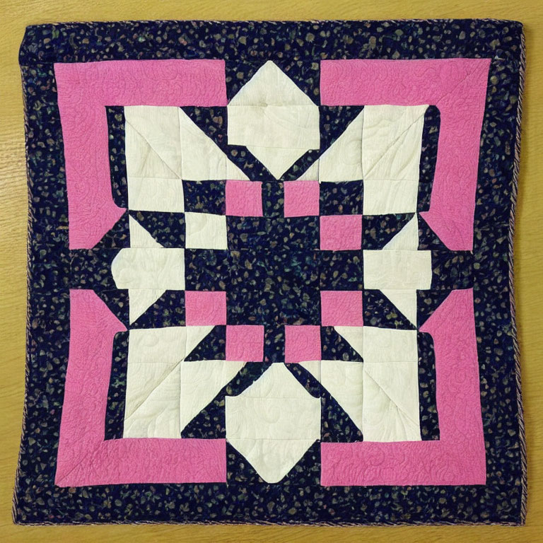 Symmetrical Pink, White, and Navy Patchwork Quilt with Dark Floral Border