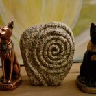 Ornate Egyptian Cat Statues with Sheep and Pyramids on Cosmic Background