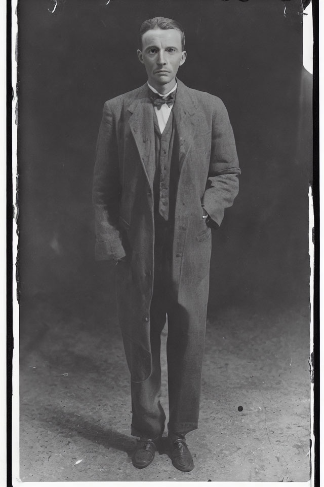 Vintage Black and White Photo: Standing Man in Suit with Bow Tie