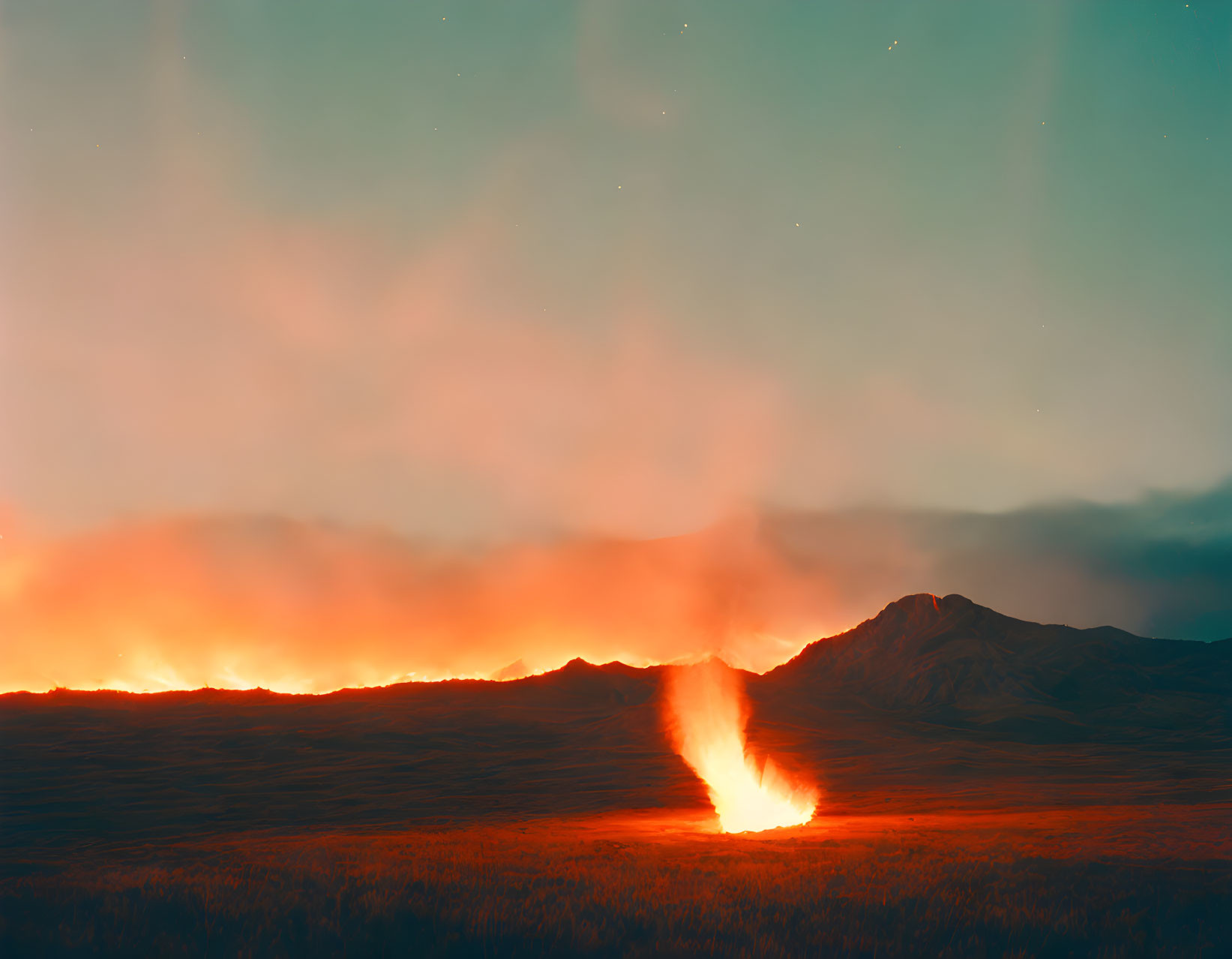 Nighttime wildfire scene with flames, grass, and mountain under starry sky