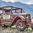 Weathered Vintage Car on Plain Under Blue Sky