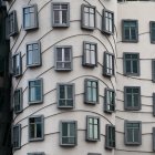 Mosaic-adorned facade of Casa Batlló with irregular windows and bone-like structure