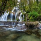 Tranquil forest scene with cascading waterfall