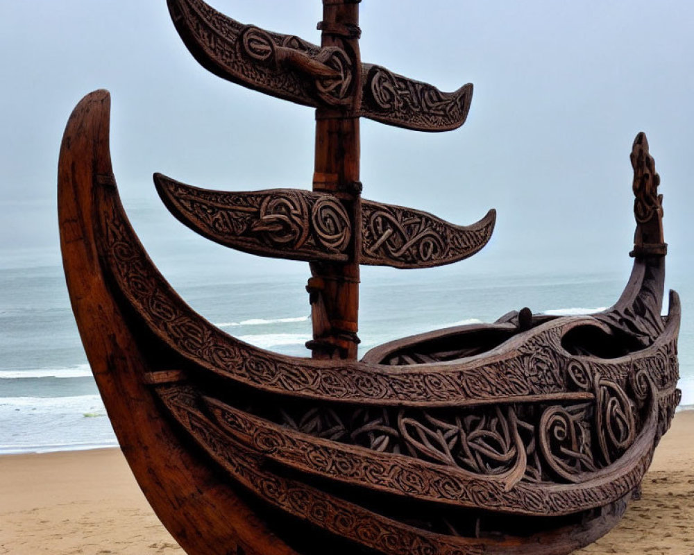 Ornate Wooden Boat with Carved Designs on Sandy Beach