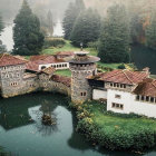 Overgrown castle in dense forest with red foliage and misty ambiance