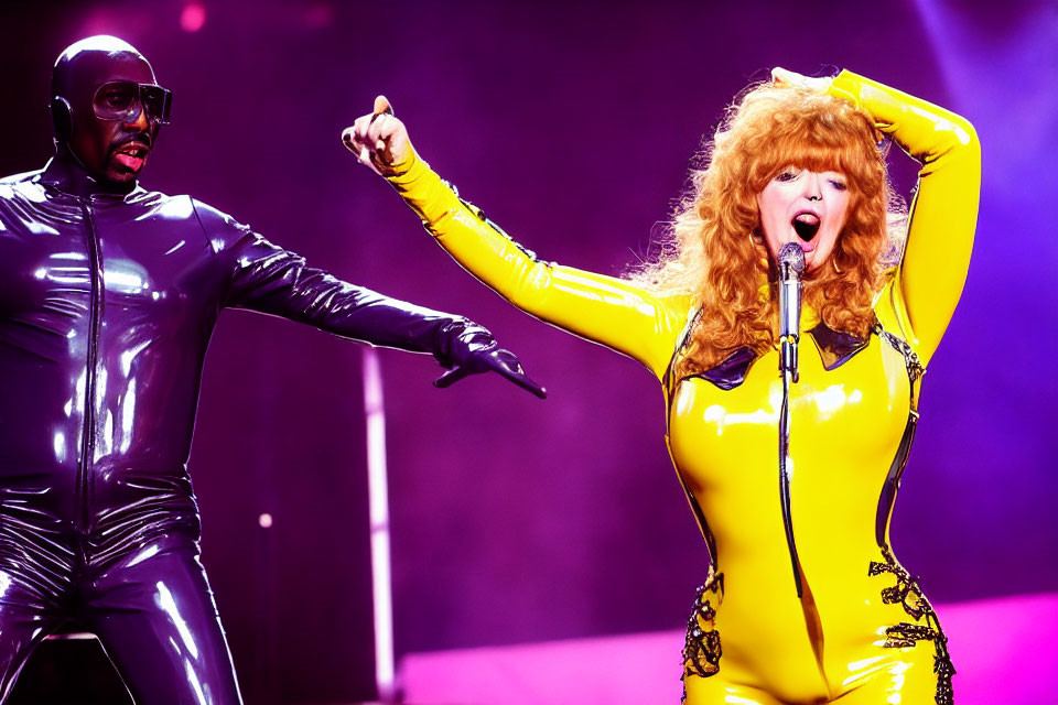 Dynamic Stage Performance: Shiny Black Outfit vs. Bright Yellow Jumpsuit