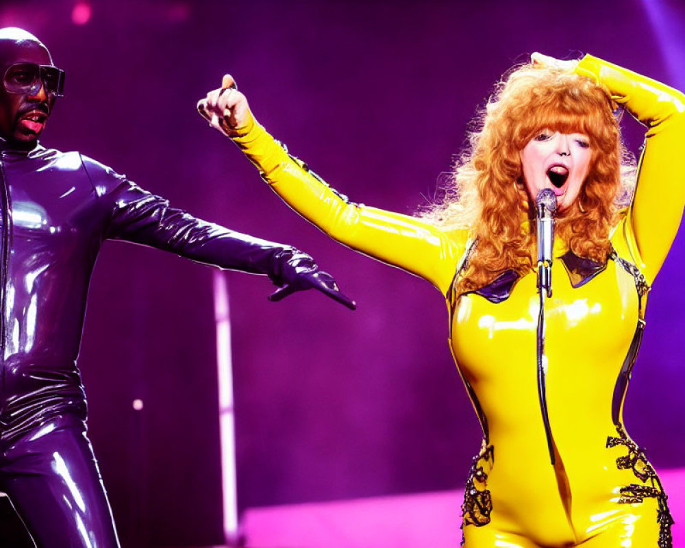 Dynamic Stage Performance: Shiny Black Outfit vs. Bright Yellow Jumpsuit