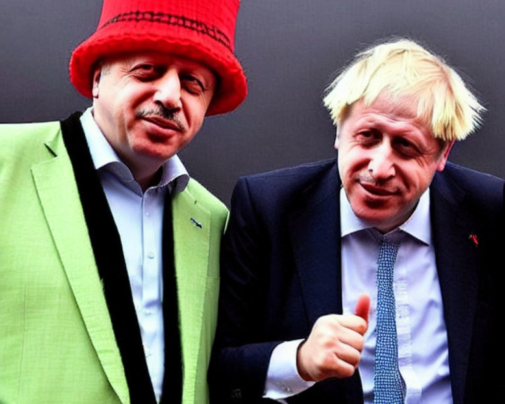 Men in bright green suit and red hat with disheveled blond man giving thumbs-up