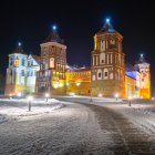 Snowy night scene: Illuminated castle in gentle snowfall