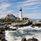 Scenic coastal view with white lighthouse on rugged cliffs