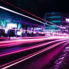 Neon-lit city street at night with wet pavement and blurred motion